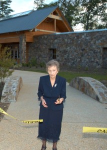Mary Lea Simpkins cuts the ribbon to open the A.E. Finley Center for visitors at Historic Yates Mill County Park in 2006.